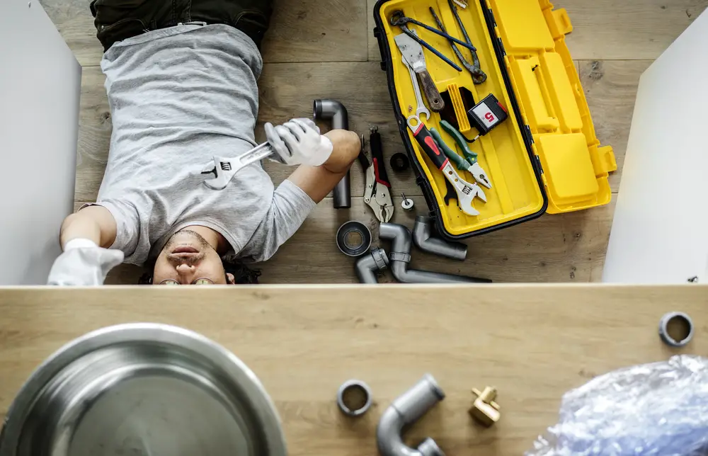 plumber fixing kitchen sink