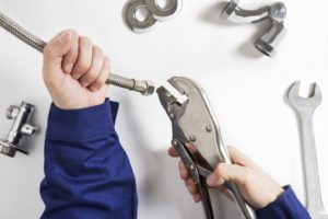 hands of commercial plumber at work