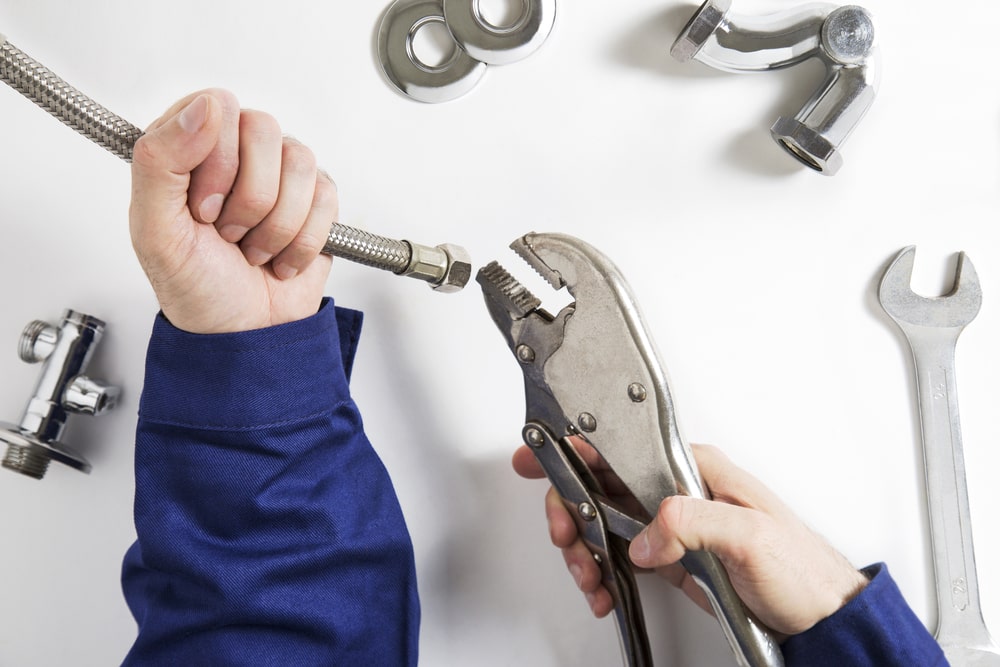 hands of commercial plumber at work