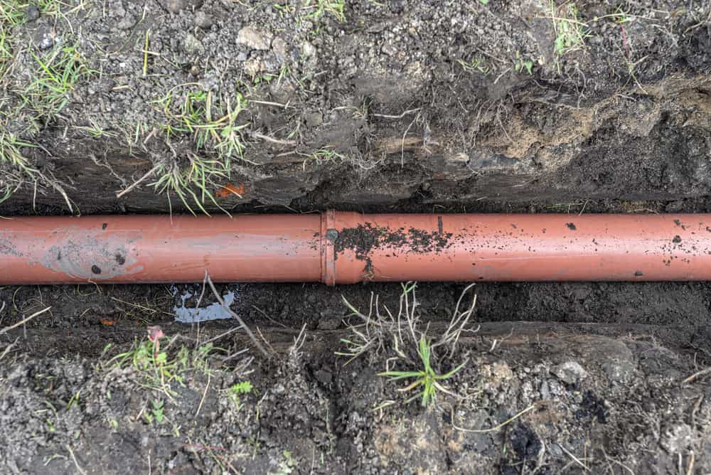 orange plastic pipe from a septic tank