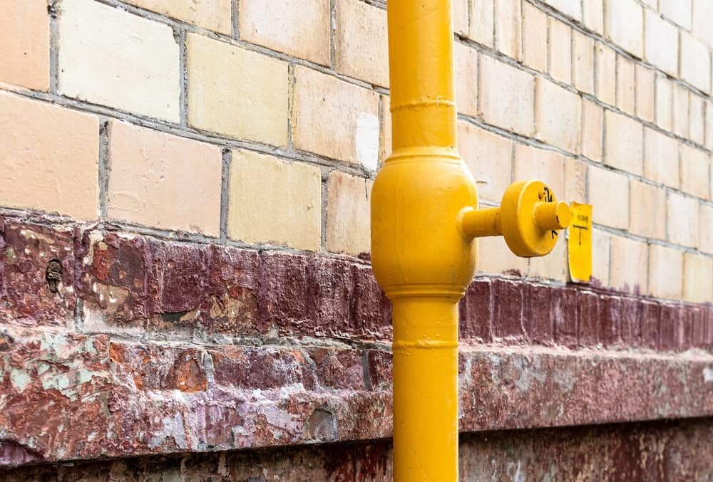 Yellow Gas Pipe on Wall of Urban House