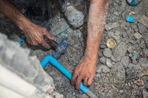 Plumber is Hammering the PVC Pipe